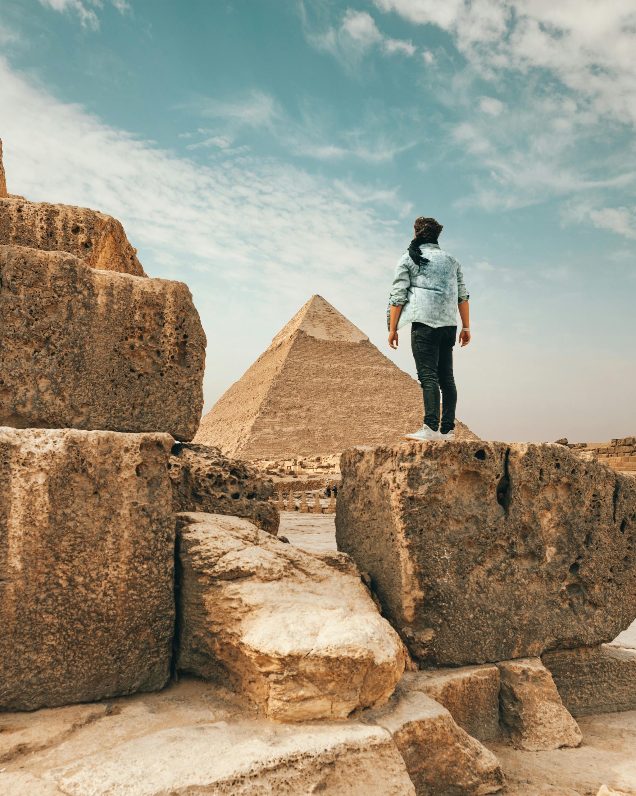 A traveler admiring the ancient Pyramids of Giza, an iconic symbol of Egypt.